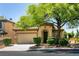 Charming single-story home with a well-manicured lawn and mature shade tree in a suburban neighborhood at 9025 Rusty Rifle Ave, Las Vegas, NV 89143