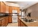 Traditional kitchen with stainless steel sink and adjacent great room at 9025 Rusty Rifle Ave, Las Vegas, NV 89143