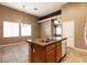 Kitchen island features double sink, granite countertop and additional cabinets at 9025 Rusty Rifle Ave, Las Vegas, NV 89143
