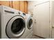 Bright laundry room with front loading LG washer and dryer, plus storage cabinets for convenience at 9025 Rusty Rifle Ave, Las Vegas, NV 89143