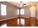 Bright and airy living room with hardwood floors, large windows, and a ceiling fan at 9025 Rusty Rifle Ave, Las Vegas, NV 89143