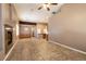 Open-concept living area with tiled flooring, a fireplace, and a view into the dining and kitchen areas at 9025 Rusty Rifle Ave, Las Vegas, NV 89143