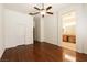 Spacious main bedroom with hardwood floors, ceiling fan, and ensuite bath at 9025 Rusty Rifle Ave, Las Vegas, NV 89143