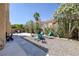 Backyard featuring a covered patio and a gravel area with a fire pit and patio seating at 9428 Sierra Summit Ave, Las Vegas, NV 89134