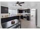 Well-lit kitchen featuring stainless steel appliances, dark cabinets, and a table with bench seating at 9428 Sierra Summit Ave, Las Vegas, NV 89134