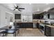 Modern kitchen with granite countertops, dark cabinets, stainless steel appliances, and a large island at 9428 Sierra Summit Ave, Las Vegas, NV 89134
