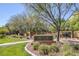 Community park with a playground, green grass, and a stone welcome sign at 9428 Sierra Summit Ave, Las Vegas, NV 89134