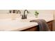 Bathroom vanity features a white countertop, dark faucet, and decorative accents at 9490 Thunder Sky St # 102, Las Vegas, NV 89178