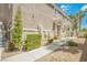 Charming townhome featuring well-maintained landscaping and a welcoming walkway at 9490 Thunder Sky St # 102, Las Vegas, NV 89178