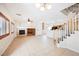 Spacious living room featuring fireplace, open layout, and adjoining kitchen area, ideal for entertaining at 9490 Thunder Sky St # 102, Las Vegas, NV 89178