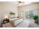 Serene main bedroom boasting private balcony access and neutral tones, creating a relaxing retreat at 9490 Thunder Sky St # 102, Las Vegas, NV 89178