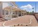 Expansive backyard with covered patio, gravel landscaping, and privacy fence at 9785 Turtle Head Ct, Las Vegas, NV 89117