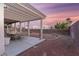Cozy backyard features a covered patio, rock landscaping, and plenty of space for relaxation at 9785 Turtle Head Ct, Las Vegas, NV 89117