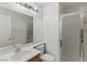 Bathroom featuring a single sink, a toilet, a large mirror, and a glass-enclosed shower at 9785 Turtle Head Ct, Las Vegas, NV 89117