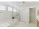 Serene bathroom featuring a soaking tub, separate shower, and ample natural light at 9785 Turtle Head Ct, Las Vegas, NV 89117