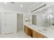 Bright bathroom with double sinks, vanity, and walk in shower at 9785 Turtle Head Ct, Las Vegas, NV 89117