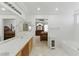 Elegant bathroom featuring dual vanities, a soaking tub, and a view of the main bedroom at 9785 Turtle Head Ct, Las Vegas, NV 89117