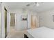 Bright bedroom featuring neutral color palette, carpet, and doors to bathroom and closet at 9785 Turtle Head Ct, Las Vegas, NV 89117