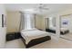 Bright bedroom featuring a neutral color palette, a ceiling fan, mirrored closet doors, and comfortable carpet at 9785 Turtle Head Ct, Las Vegas, NV 89117