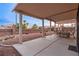Spacious covered patio with outdoor dining area, ideal for enjoying the backyard scenery at 9785 Turtle Head Ct, Las Vegas, NV 89117
