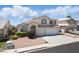 Charming two-story home with a well-maintained yard, two-car garage, and classic desert landscaping at 9785 Turtle Head Ct, Las Vegas, NV 89117