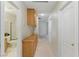 Hallway featuring access to other rooms, storage cabinets, and neutral color palette at 9785 Turtle Head Ct, Las Vegas, NV 89117
