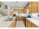 Functional kitchen with wood cabinets, stainless steel appliances, bright countertop, and a clean design at 9785 Turtle Head Ct, Las Vegas, NV 89117