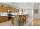 Bright, open kitchen with stainless steel appliances and breakfast bar seating at 9785 Turtle Head Ct, Las Vegas, NV 89117
