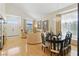 Bright living room boasts hardwood floors, large windows, an elegant chandelier, and an open layout at 9785 Turtle Head Ct, Las Vegas, NV 89117