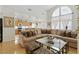 Open-concept living area featuring hardwood floors, a large sectional, and open access to the kitchen at 9785 Turtle Head Ct, Las Vegas, NV 89117
