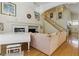 Cozy living room features a fireplace, piano, plush sofa, and staircase at 9785 Turtle Head Ct, Las Vegas, NV 89117