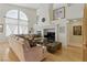 Bright living room boasts a fireplace, large window, comfortable seating, and hardwood floors at 9785 Turtle Head Ct, Las Vegas, NV 89117