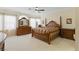 Spacious main bedroom with a tray ceiling, ceiling fan, and large windows at 9785 Turtle Head Ct, Las Vegas, NV 89117