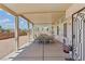 Large covered patio with outdoor dining and decorative ironwork at 9785 Turtle Head Ct, Las Vegas, NV 89117