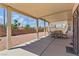 Covered patio featuring outdoor dining set and beautiful landscaping at 9785 Turtle Head Ct, Las Vegas, NV 89117