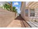 View of the side yard with a covered patio and privacy wall at 9785 Turtle Head Ct, Las Vegas, NV 89117