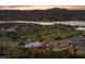 Panoramic aerial view of a luxury home with a pool and lush landscaping, nestled near a tranquil lake at 1 Costa Del Sol Ct, Henderson, NV 89011