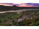 Breathtaking aerial view showcases a sprawling estate with a pool, golf course, a scenic lake, and rolling hills at 1 Costa Del Sol Ct, Henderson, NV 89011