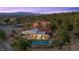 Luxury home with pool, fire pit, and mountain views, set amongst mature trees and greenery, and manicured landscaping at 1 Costa Del Sol Ct, Henderson, NV 89011