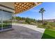 Spacious backyard featuring a covered patio, desert landscape, a palm tree, and views of the mountains at 1 Costa Del Sol Ct, Henderson, NV 89011