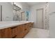 Bathroom showcasing wood cabinets, a white countertop, and a shower decorated with decorative mosaic tiles at 1 Costa Del Sol Ct, Henderson, NV 89011