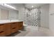 Modern bathroom featuring a stylish vanity and a walk-in shower with black and white patterned tiles at 1 Costa Del Sol Ct, Henderson, NV 89011