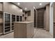 Expansive walk-in closet with extensive shelving, cabinets, and central storage at 1 Costa Del Sol Ct, Henderson, NV 89011