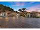 Spacious home with a circular entryway, 3-car garage, and a large brick driveway lined with mature palm trees at 1 Costa Del Sol Ct, Henderson, NV 89011