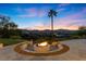 Inviting fire pit area with stone benches, perfect for outdoor gatherings with stunning mountain views at sunset at 1 Costa Del Sol Ct, Henderson, NV 89011