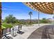 Stylish outdoor patio with a cozy fire pit, seating, and stunning views of the surrounding landscape at 1 Costa Del Sol Ct, Henderson, NV 89011