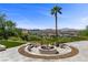 Inviting fire pit with seating, nestled in a landscaped backyard, offering panoramic views of the mountains at 1 Costa Del Sol Ct, Henderson, NV 89011