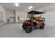Clean and organized garage with epoxy flooring and modern cabinets, equipped with a stylish golf cart at 1 Costa Del Sol Ct, Henderson, NV 89011