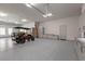 Spacious garage featuring epoxy floors, ample storage cabinets, and a golf cart for convenient mobility at 1 Costa Del Sol Ct, Henderson, NV 89011