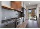 Modern kitchen with a stainless steel range, cooktop, gray cabinetry, and a large window at 1 Costa Del Sol Ct, Henderson, NV 89011